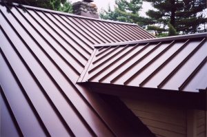 Close up view of a red metal roofing system installed on a home
